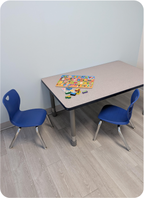 Table with children's chairs and a puzzle for skills development