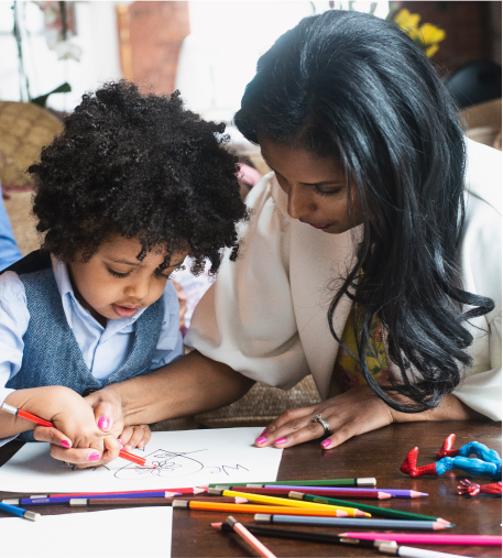 Applied Behaviour Analysis teacher with male student drawing